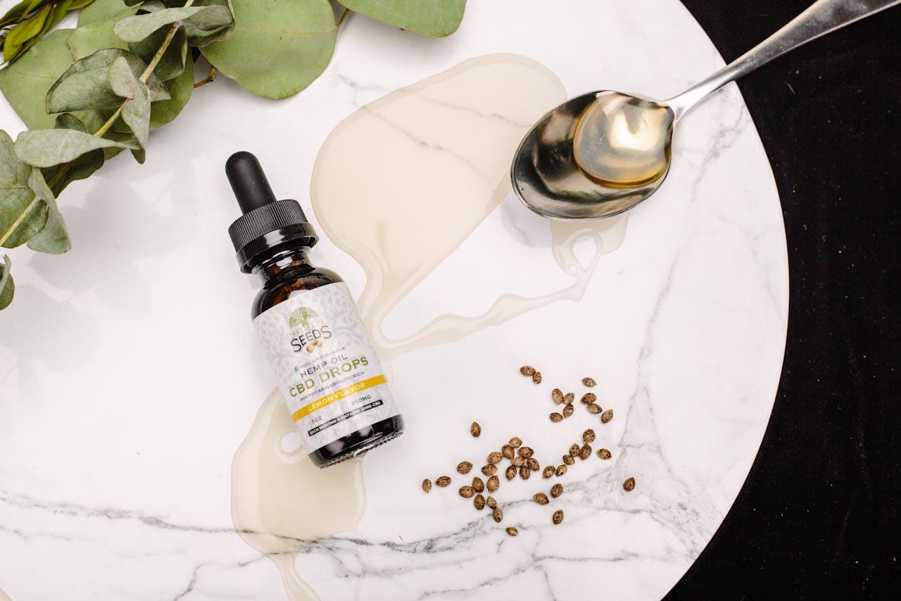 about-us CBD oil drops with seeds and eucalyptus leaves on marble. Perfect for health and wellness themes.