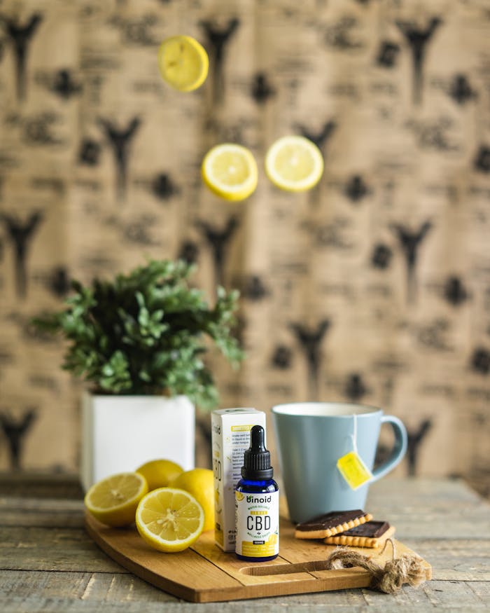 services-02 Product photography featuring CBD oil, lemons, tea cup, and rustic background, highlighting a natural and refreshing setup.