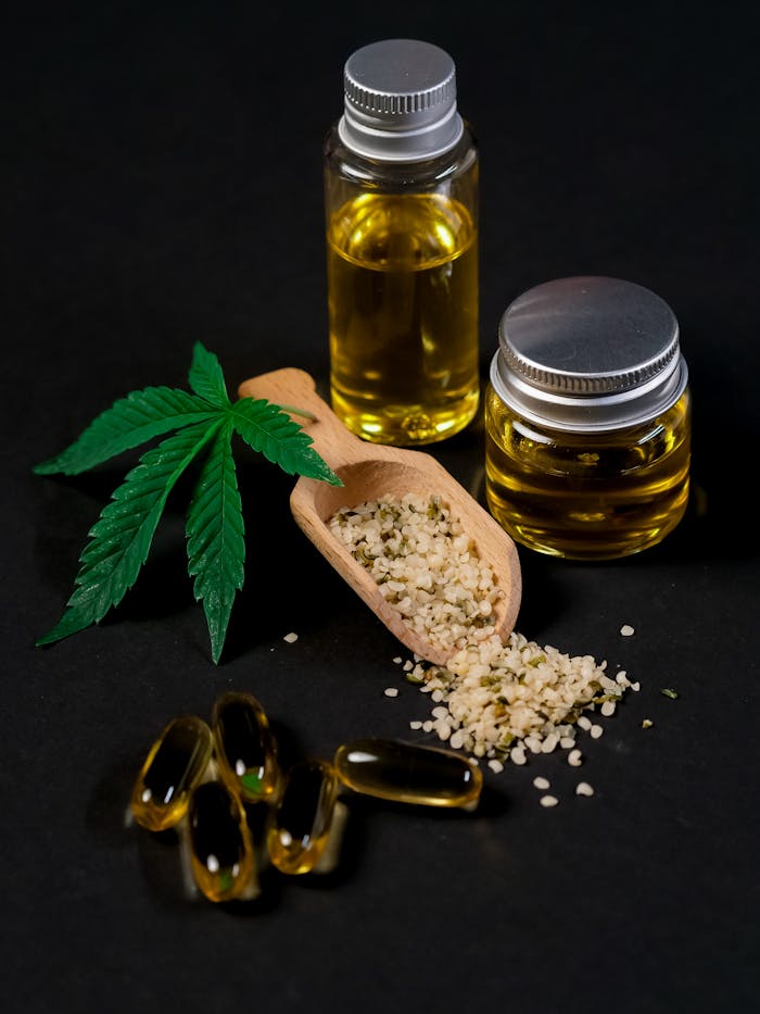 our-story A set of CBD products including oil, capsules, hemp seeds, and a cannabis leaf, presented on a dark backdrop.